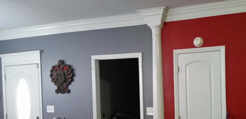 This photo shows a drastic change for this house including new sheetrock, doors, door casing, freeze board and crown shelf above the oval window front door, a half column with a stepped 4 piece crown molding. In the Flatwoods, KY; ashland, KY; Catlettsburg, KY area