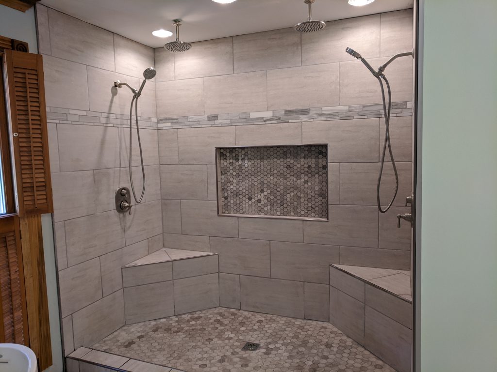 Thompson Parker Builders- Shower for two with two seats, and overhead and hand-held shower heads.