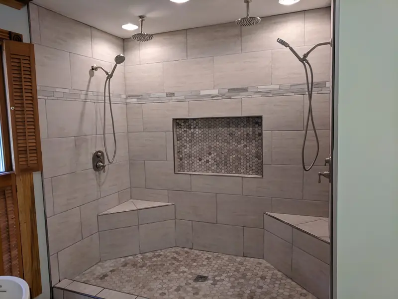 Custom tile shower for two with twin seats and dual heads