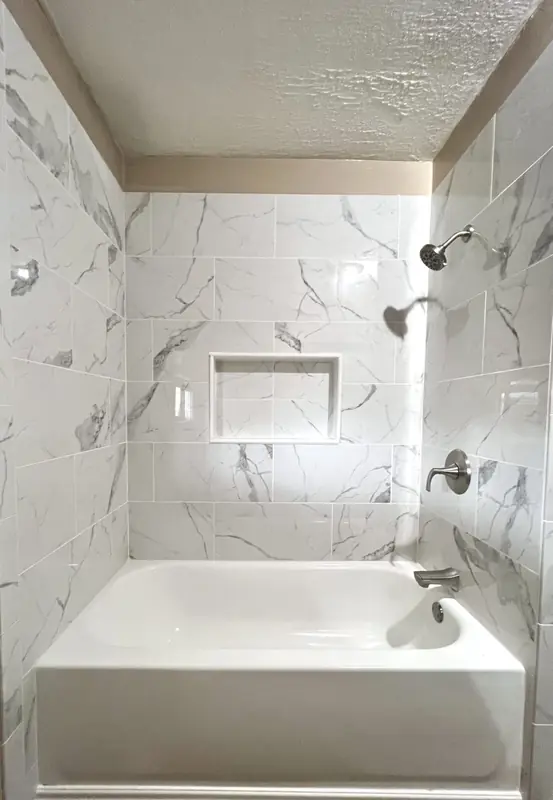 Custom marble tile shower with niche